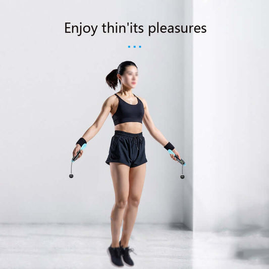 Woman using cordless digital jump rope for fitness and weight loss in a minimalistic workout space.