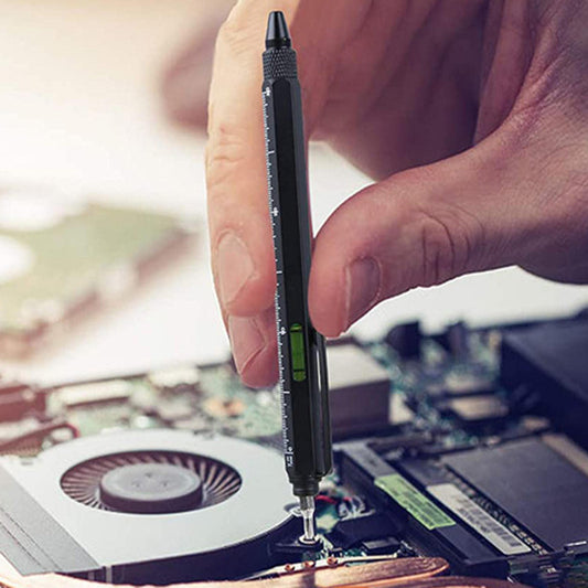 User holding a multi-functional pen tool for precision work on a circuit board.